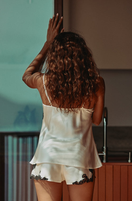 Loose-fitting silk camisole with a neckline edged in black Calais lace. | Marjolaine lingerie